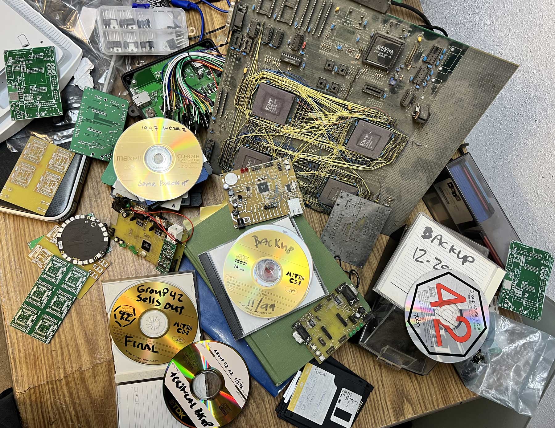 Scattered half built electronics, CDROM and floppies from the 1990s'