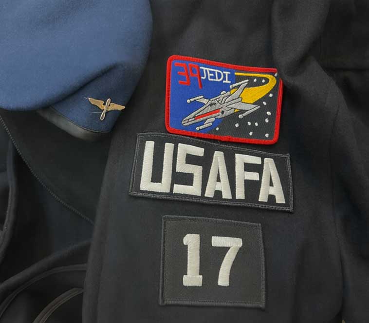 Blue USAFA cadet beret and jacket with CS-39 “Jedi” squadron patch featuring an X-wing starfighter; worn by cadets from the Class of 2017.