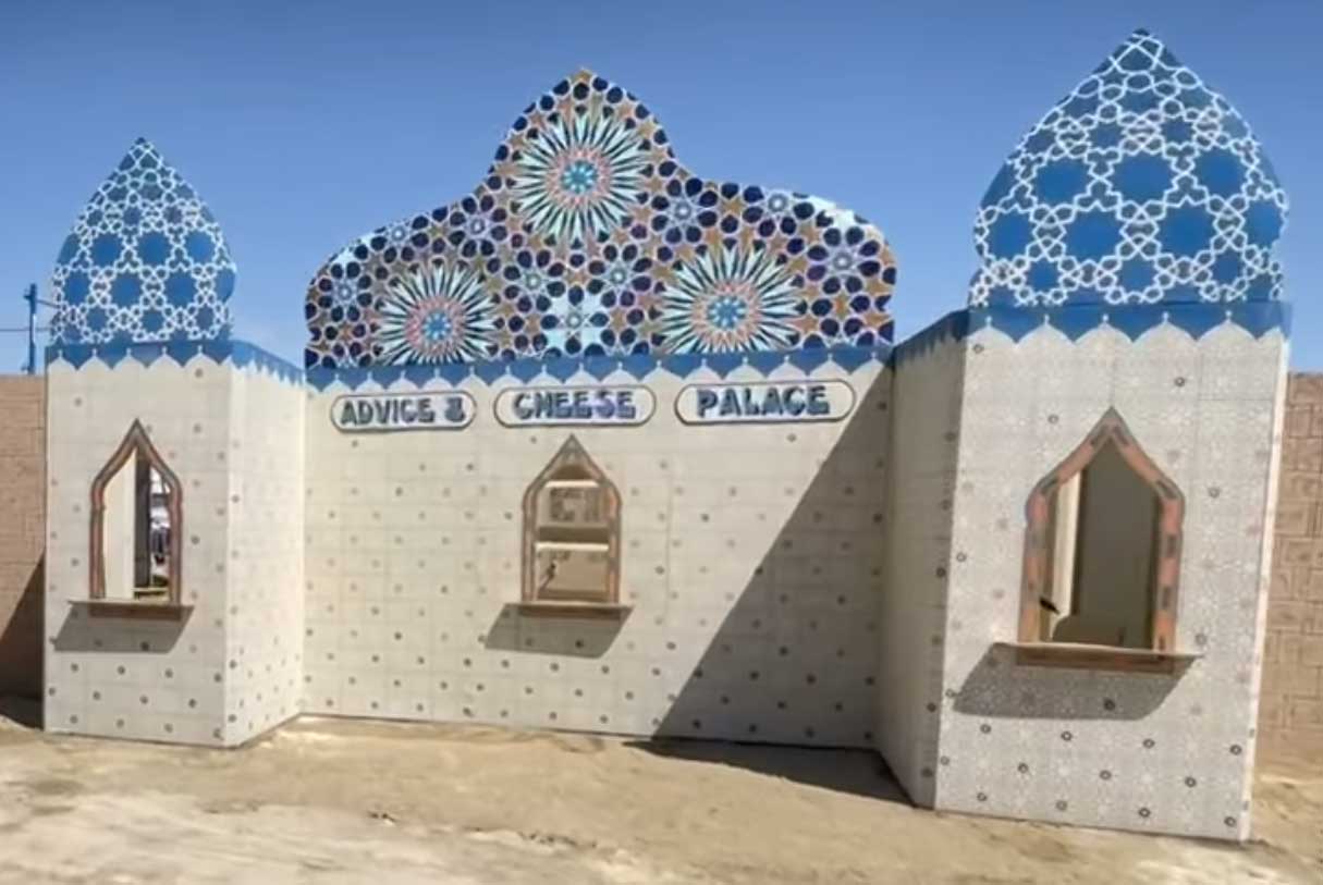 The Grilled Cheese and Advice Palace at Burning Man, a plywood castle with serving windows and at night you'd see dusty Burners waiting outside.