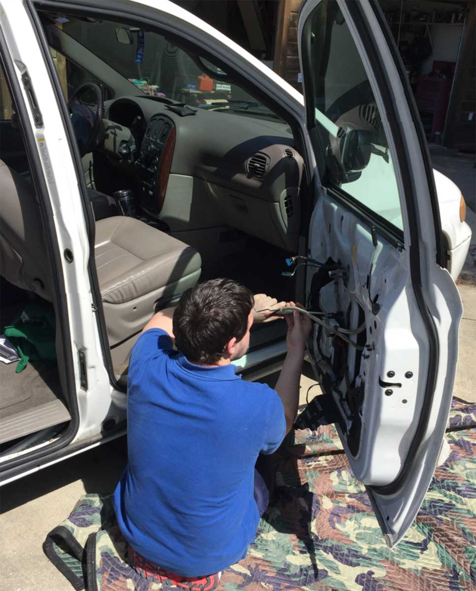 Stuart repairing the van door, 2016